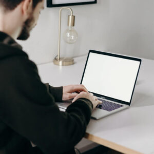 Man blogging on laptop with WordPress
