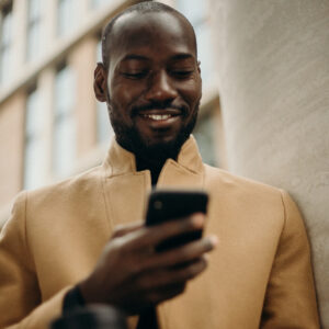 A black man using a smartphone to pay for DStv
